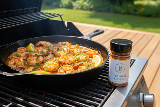 Grilled shrimp scampi in a cast iron skillet with buttery garlic lemon sauce, fresh parsley, lemon wedges, and Breeze Blends Poultry Blend seasoning