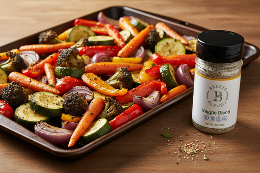 Colorful roasted mixed vegetables on a sheet pan, golden and caramelized, with Breeze Blends all-natural Veggie Blend beside the pan