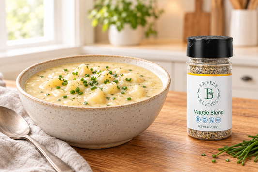 Bowl of creamy potato soup with bottle of Breeze Blends Veggie seasoning on kitchen table. lends 