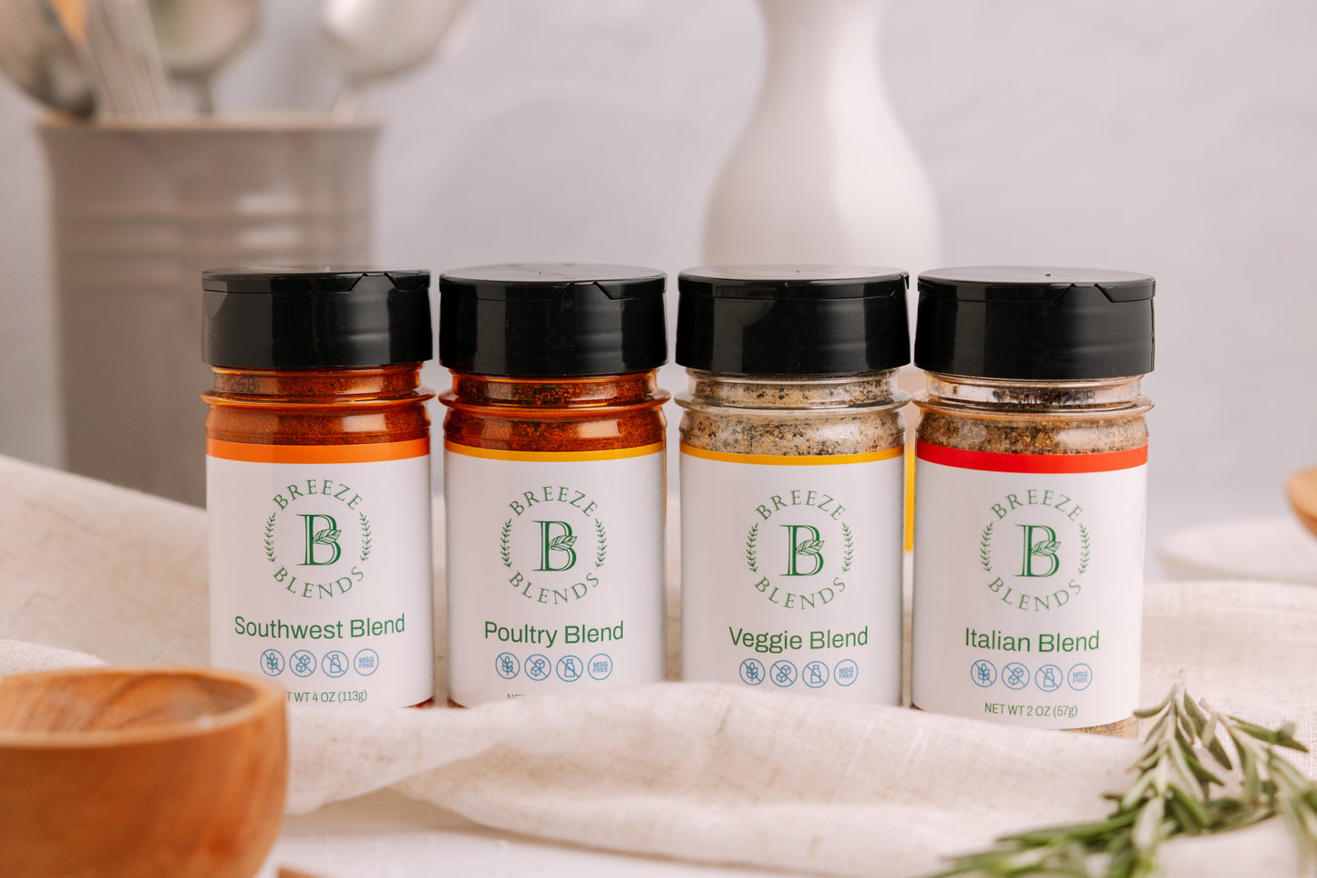 Breeze Blends 4 Pack jars on a kitchen counter with herbs in the background.