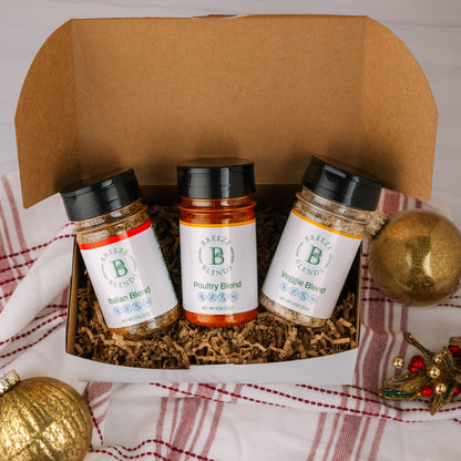 Breeze Blends Tuscan Pack three spice jars in a box with holiday decorative ornaments on a plaid fabric background