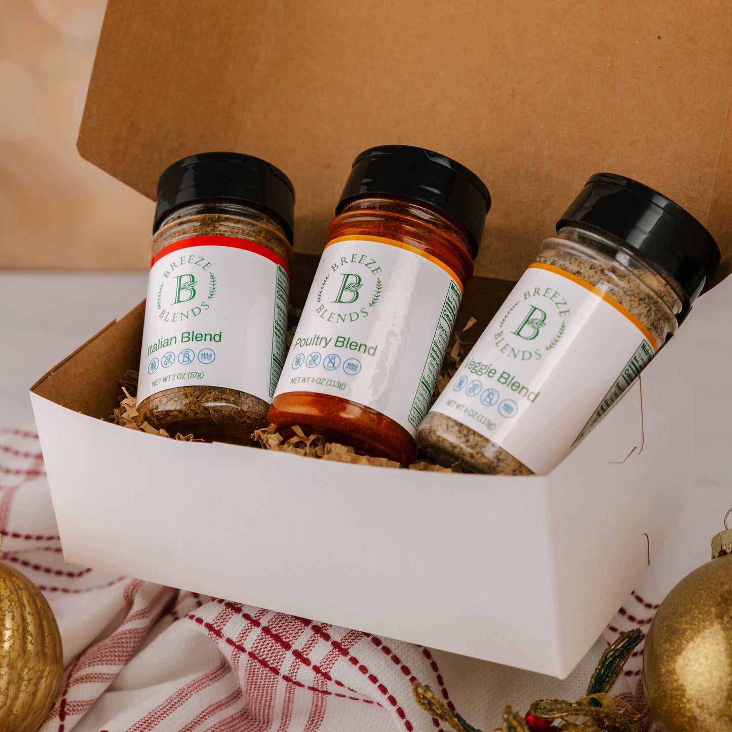 Breeze Blends Tuscan pack inside box with three spice jars with Christmas decorations.